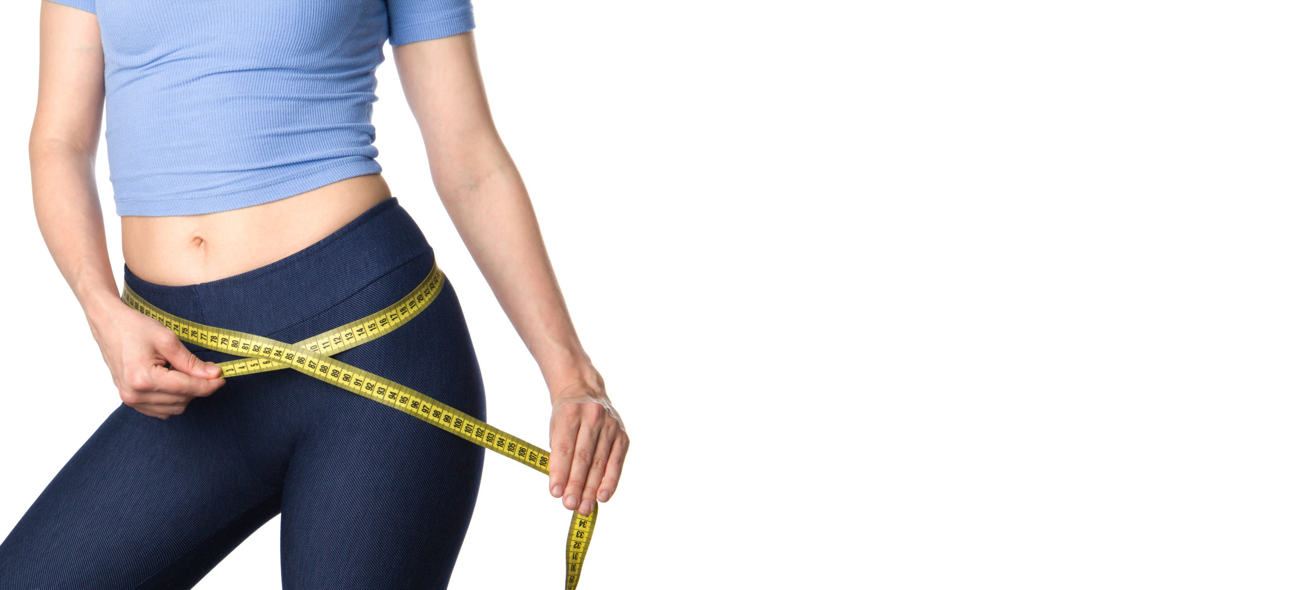 Woman measuring her body. Slim woman measuring her hips and buttocks isolated on white background. Healthy nutrition and weight losing concept. Body fat reduction. Fitness woman banner. Copy space.